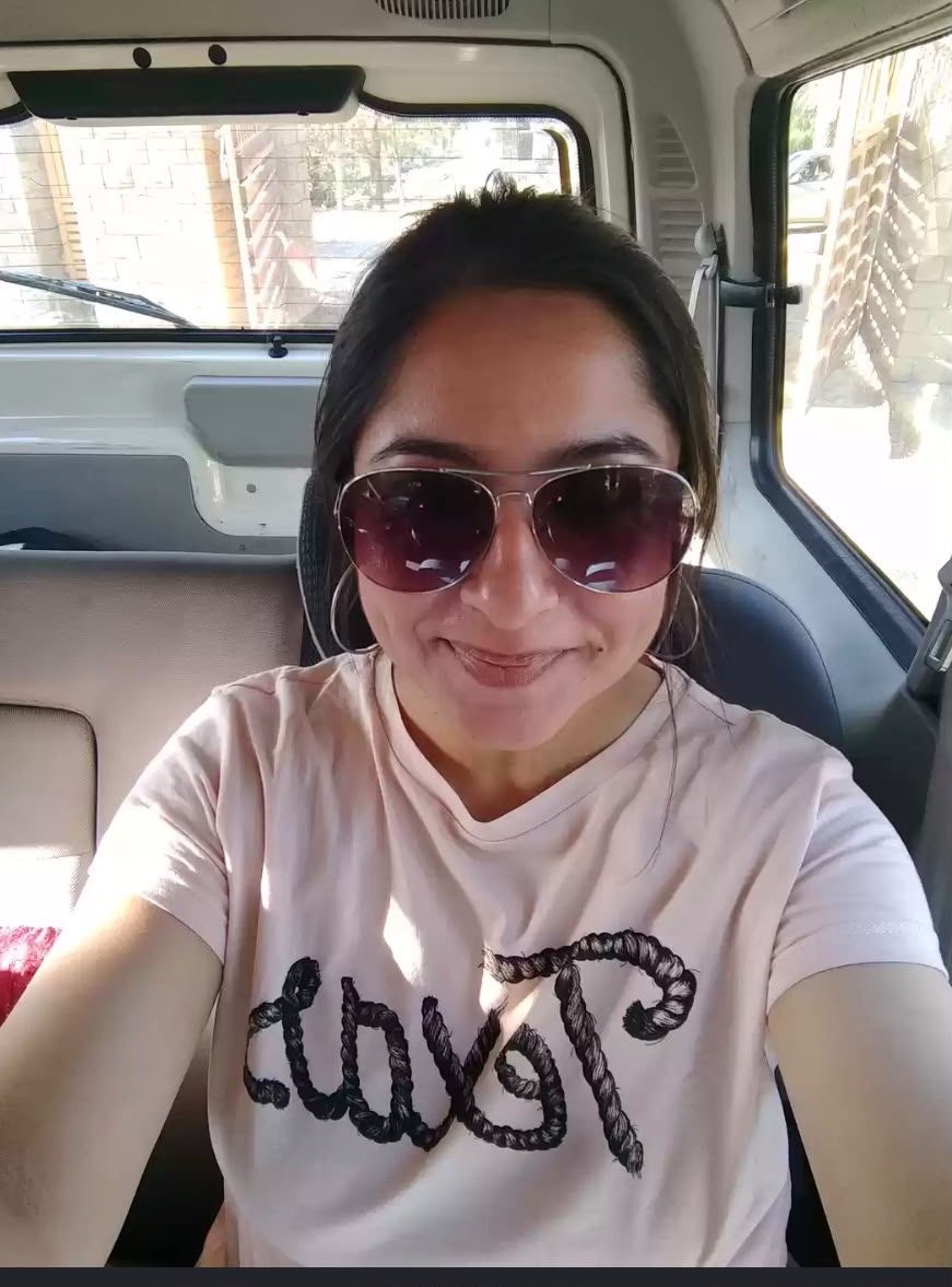 Pallavi in sunglasses with a big grin
